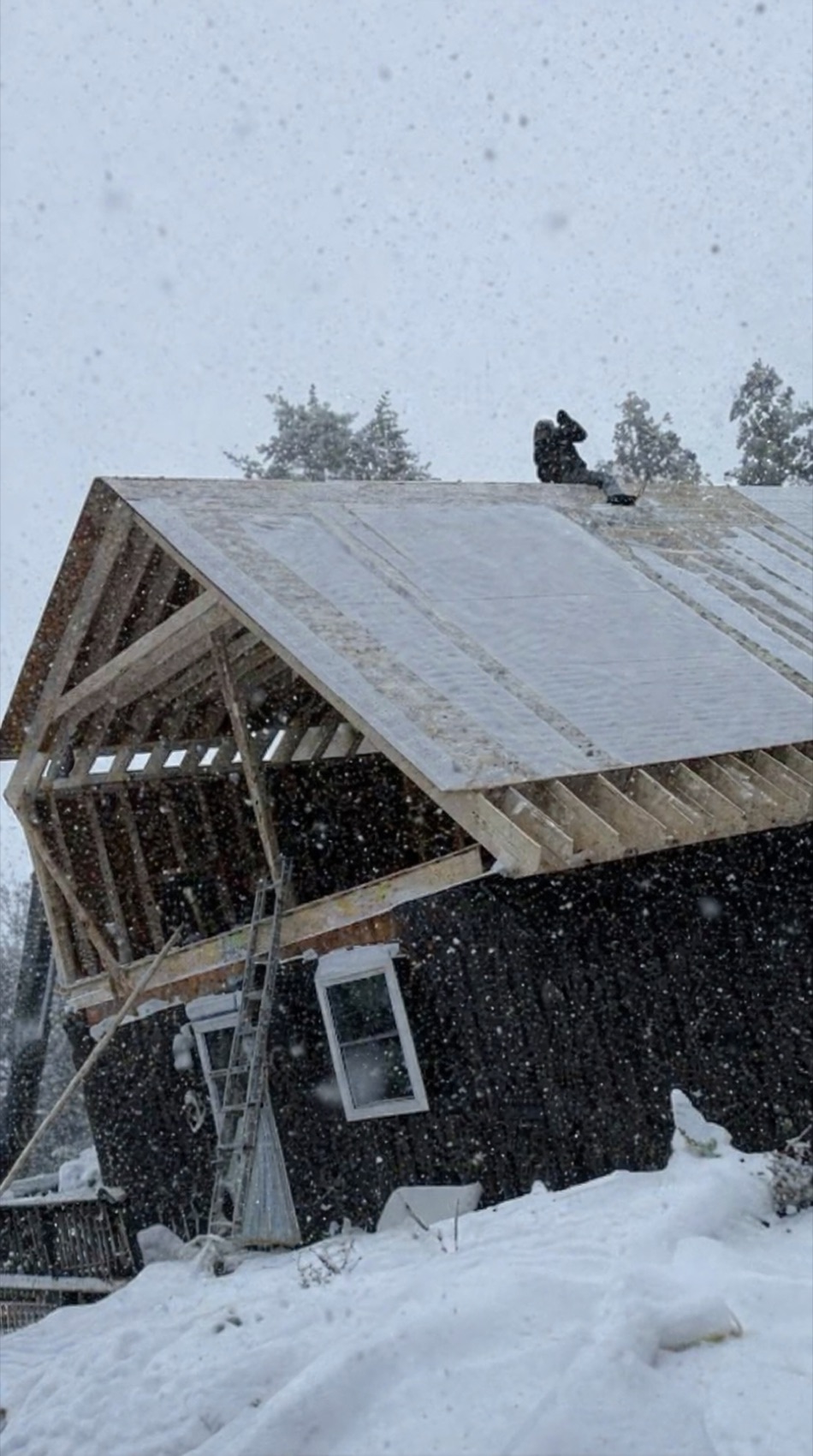 Roof framing and sheathing work during snowy weather